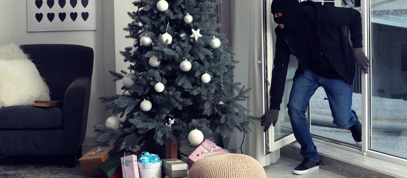 Man-walking-through-door-next-to-chritmas-tree